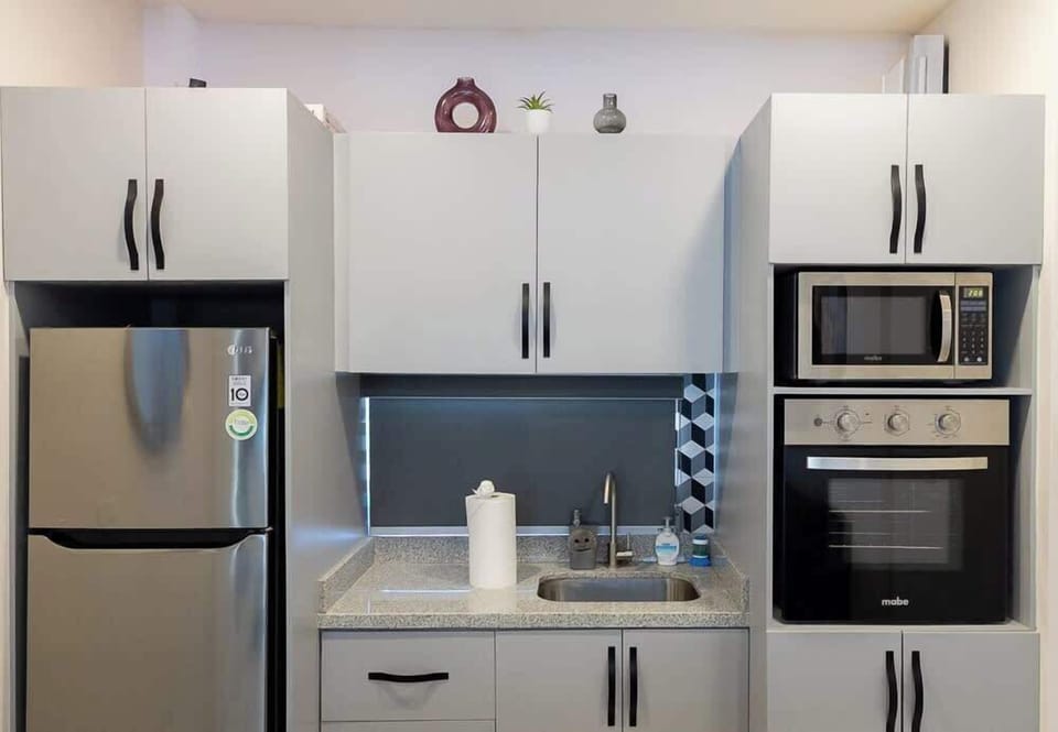 Modern kitchen w/ stainless appliances & sleek cabinetry
