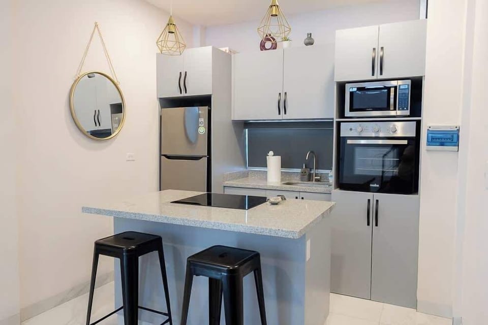 Modern kitchen w/ bar seating & stainless appliances for easy meals