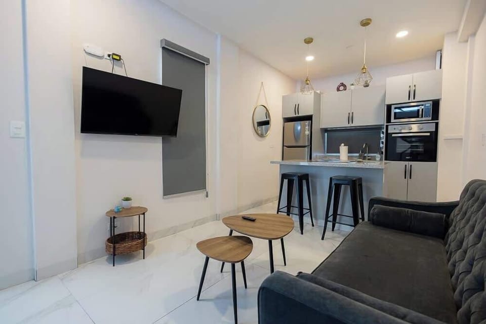 Open living space w/ TV, sofa & kitchen flow for relaxed stays