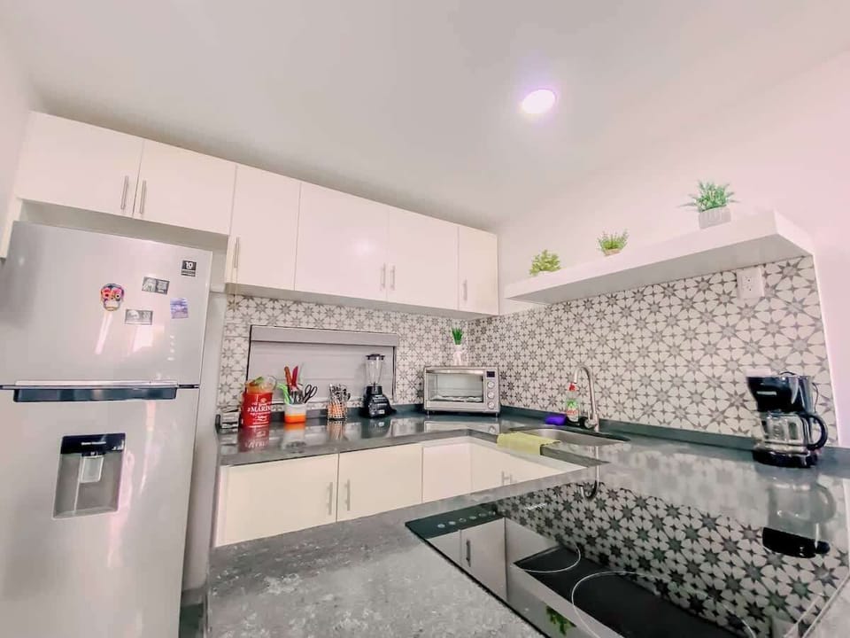 Sleek kitchen w/ modern cabinets, appliances & ample counter space