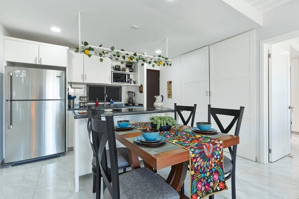Open dining area w/ bold accents flowing into a modern kitchen space