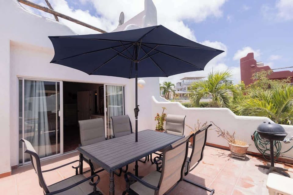 Private balcony w/ table, chairs & umbrella for outdoor lounging