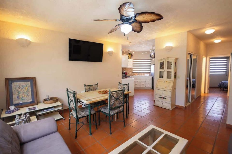 Open living & dining space w/ seating, TV & natural light