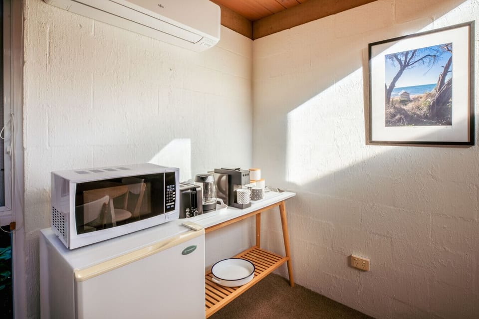 Compact kitchenette setup with coffee and tea essentials, simple and convenient