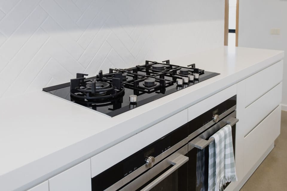 Five-burner gas cooktop and built-in oven — everything you need for home-cooked meals during your stay.