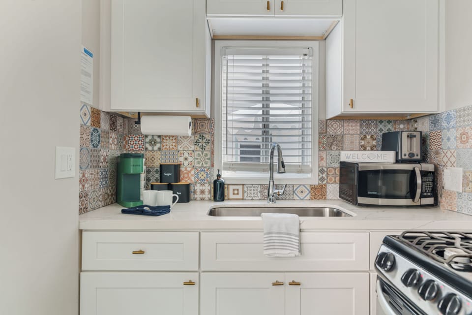Beautiful custom tilework and a convenient coffee station for your morning brew.