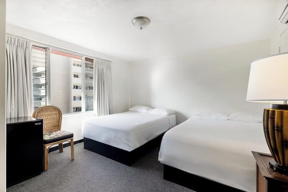 Unwind in bright twin beds with calming city views.