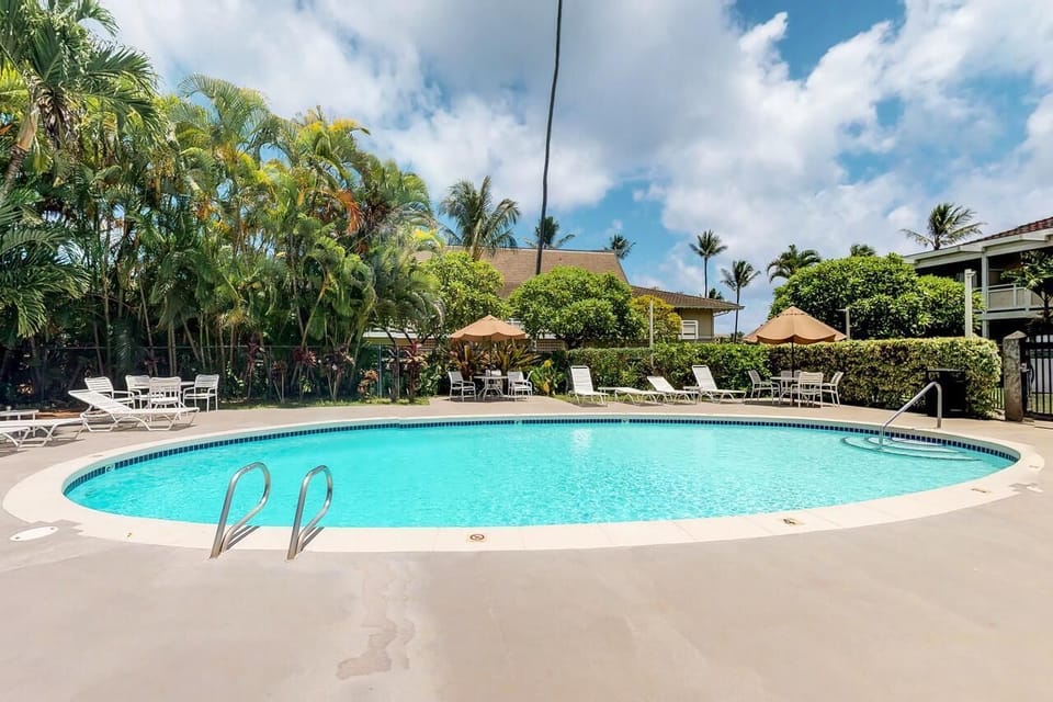Lounge poolside in the sun with plenty of chairs.