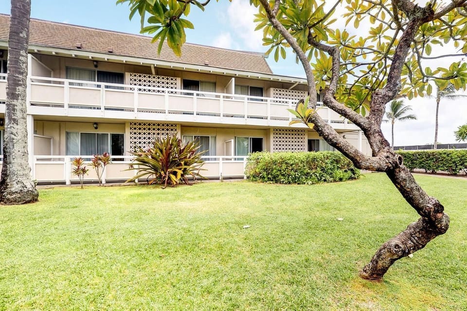 Stroll through open lawns toward your breezy island building.
