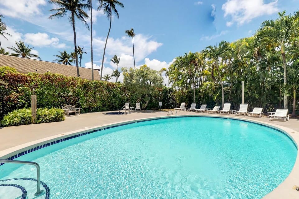 Dive into sparkling resort pool bliss under swaying palms.
