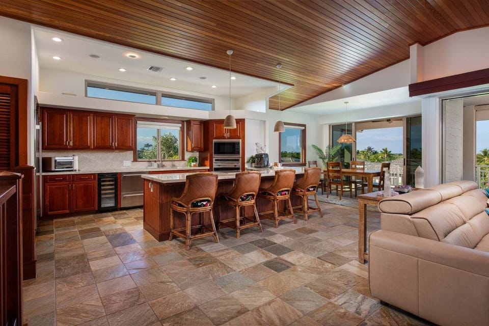 Open concept great room with island seating and wine fridge in the gourmet kitchen