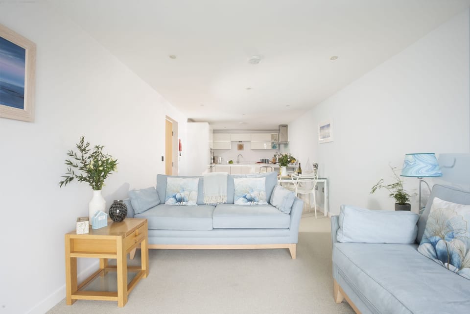 Two large comfortable sofas with open plan dining and kitchen space - 18 The Sands