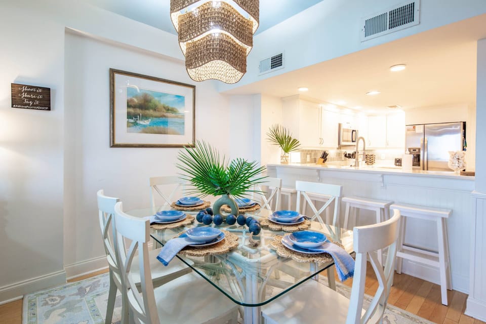 The dining table seats 6 and there are 4 stools at the kitchen counter.