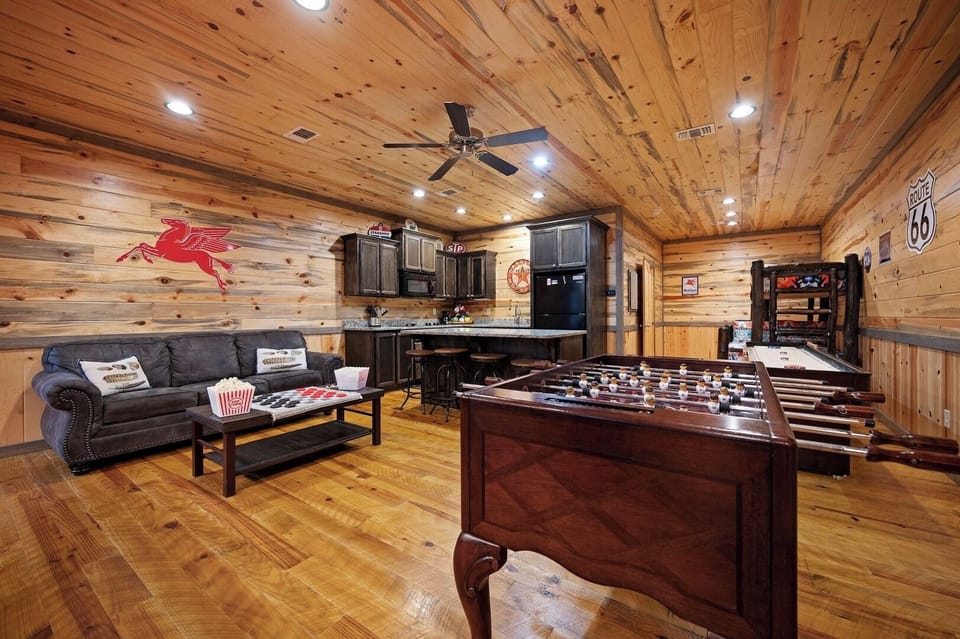 Challenge friends to foosball in your rustic game room, featuring a cozy seating area and full kitchen for snacks between matches.