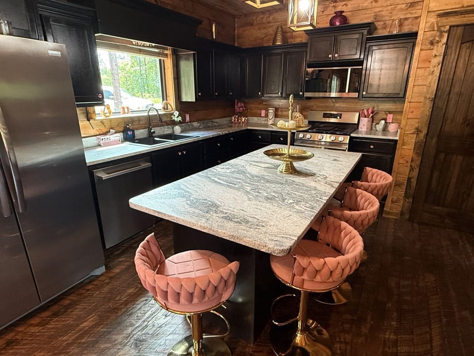 Gather around this stylish kitchen island with elegant seating, fully equipped with modern appliances and rustic charm—perfect for preparing your favorite meals and sharing stories together.