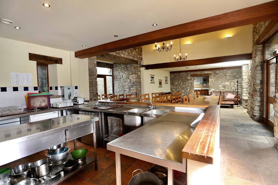 Spacious industrial kitchen and welcoming dining area for guests