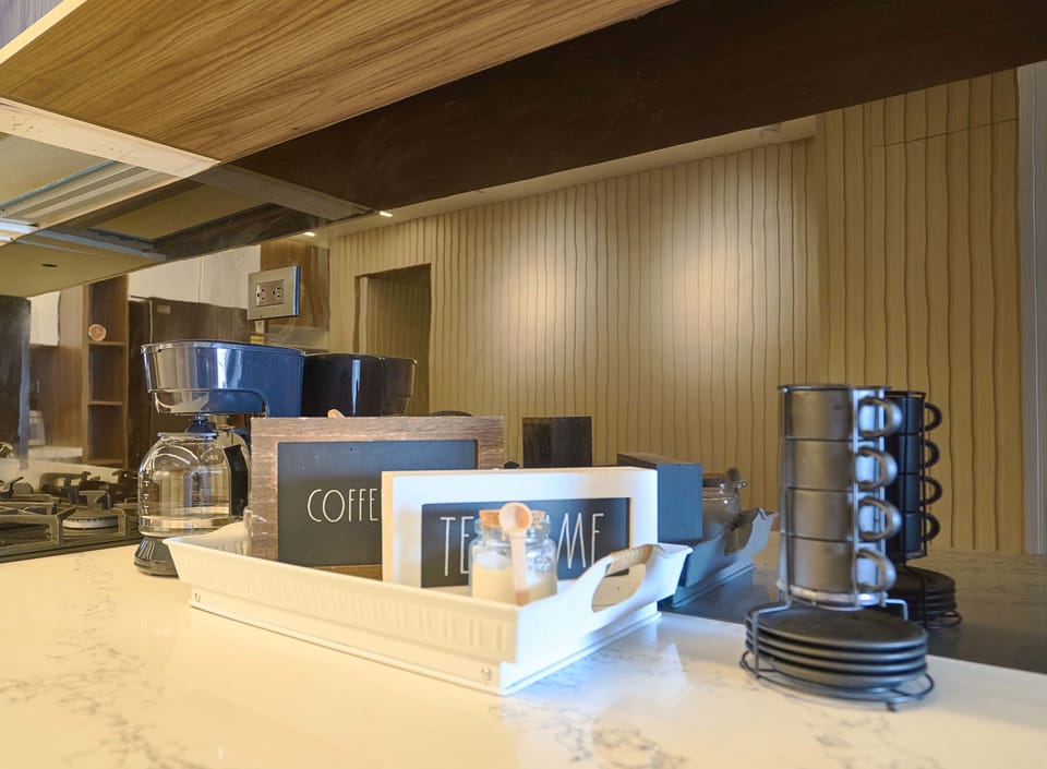 Fully equipped with stainless steel appliances, an American-style fridge, granite countertops, and a breakfast island—this kitchen is ready for culinary creations.