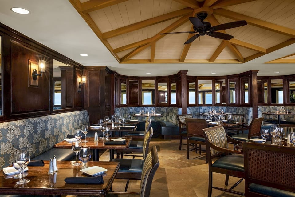 Dine in relaxed elegance beneath warm wood beams and lights.