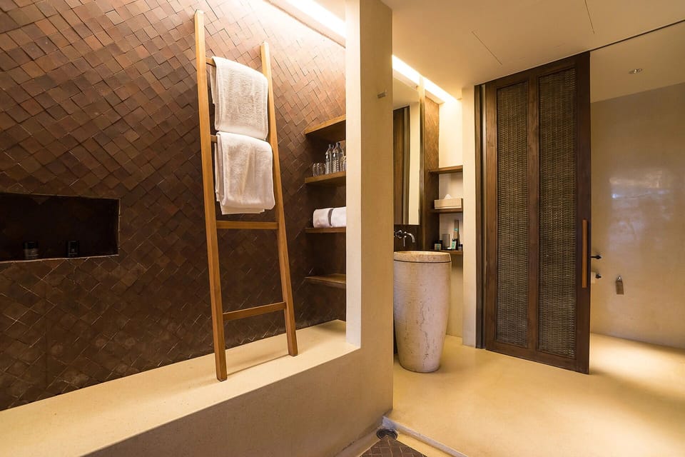 Pamper yourself with plush towels and elegant stone basin.