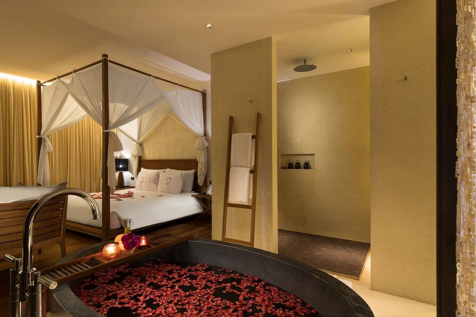 Unwind with rose-petal soaks beside your romantic canopy bed.