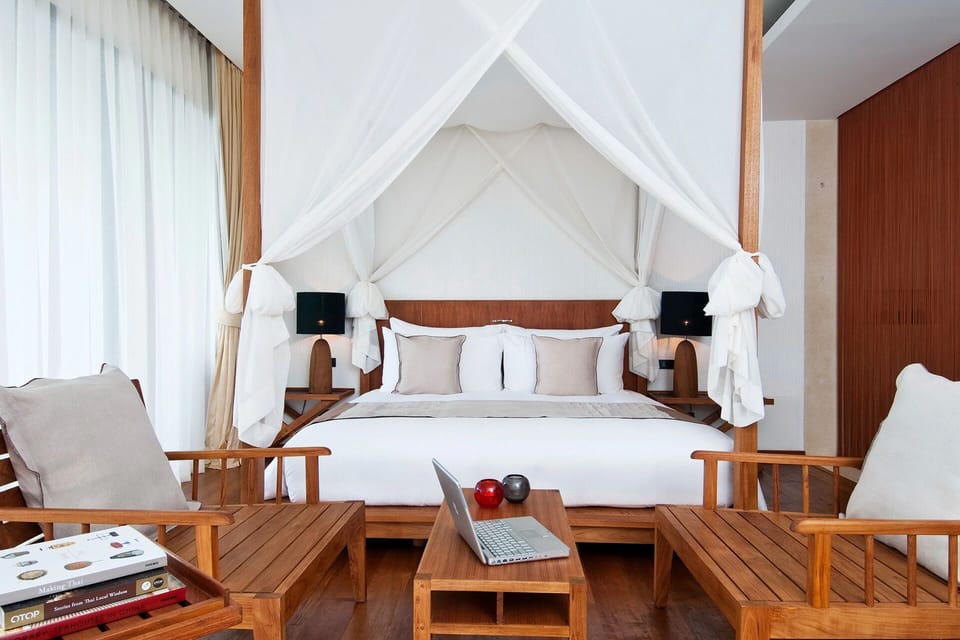 Sink into a cloud-soft canopy bed framed by sunlight.