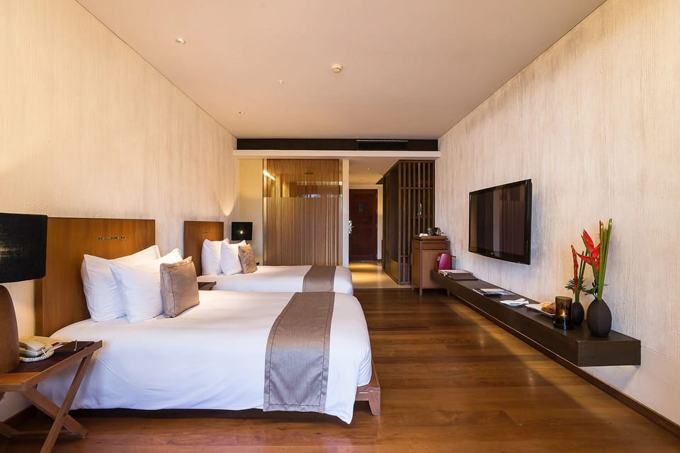 Stretch out on crisp twin beds in a calm, modern retreat.