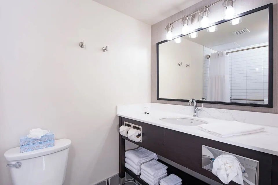 Refresh at a spacious vanity with bright, flattering lighting.