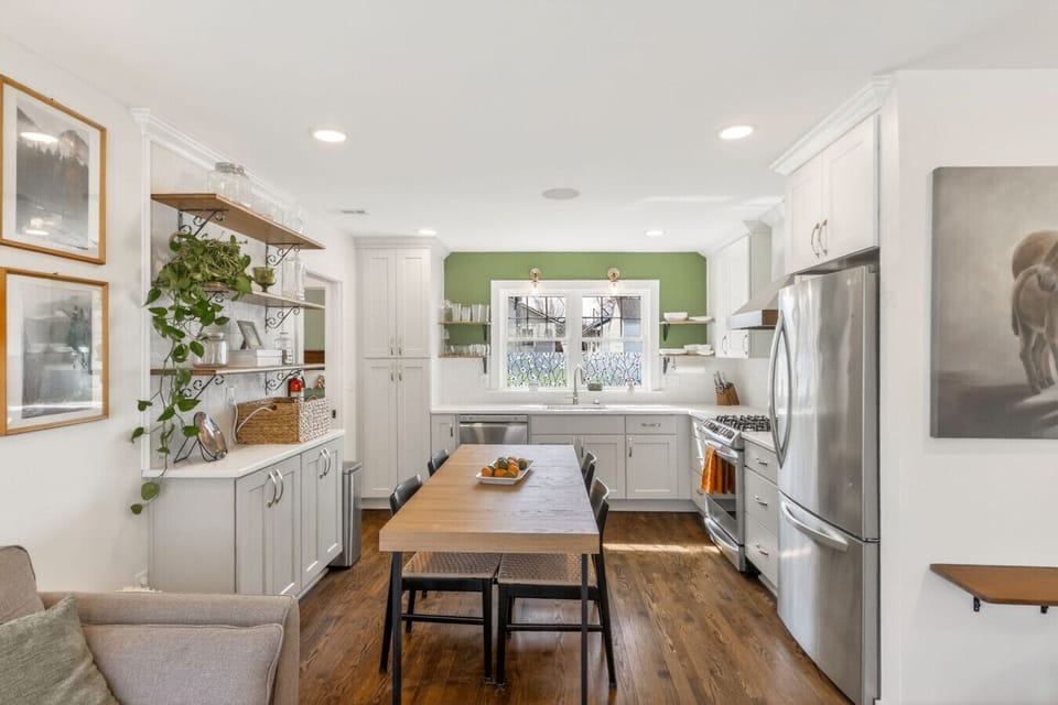 A beautifully updated kitchen with sleek white cabinetry, warm wood accents, and a central island—perfect for cooking and gathering.