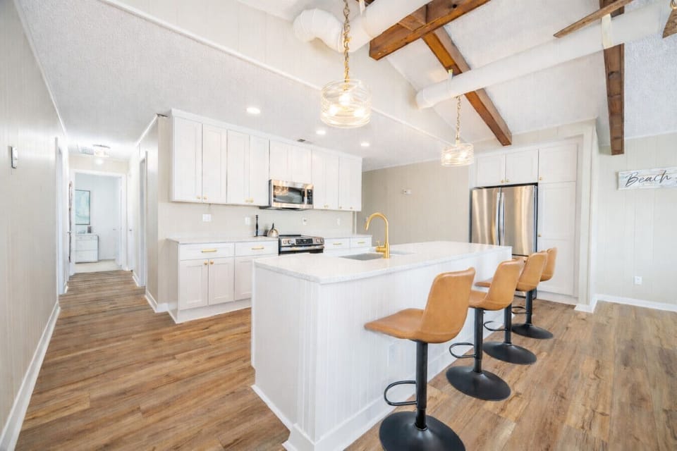 Modern kitchen with large island, bar seating, and stylish finishes—ideal for cooking, dining, and entertaining.