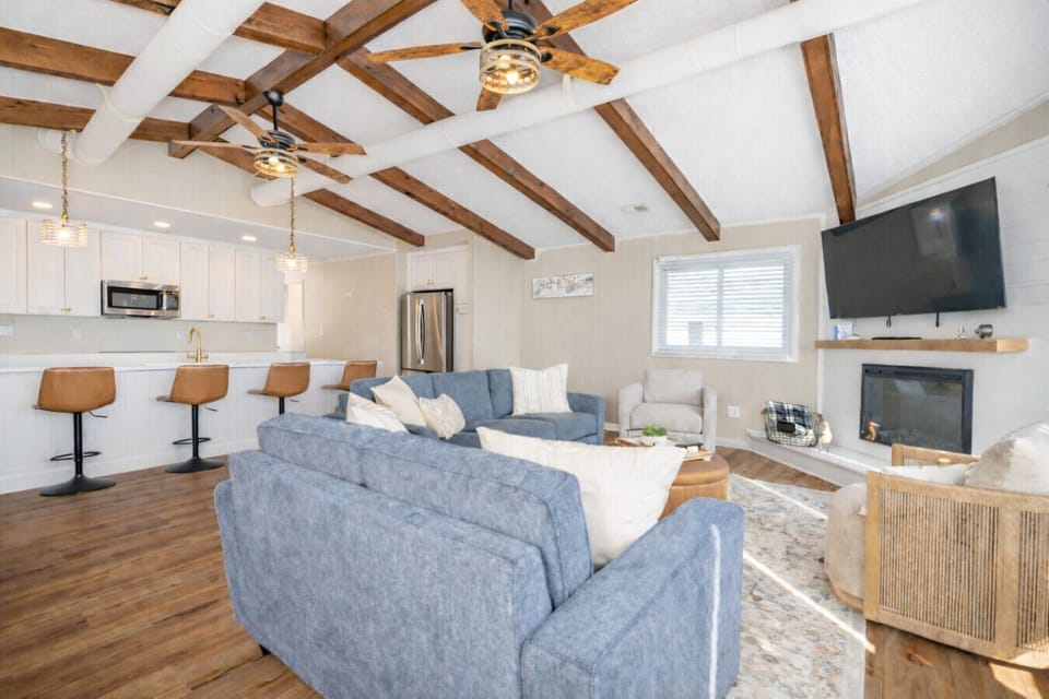 Beautiful open living space with vaulted ceilings, exposed beams, and comfortable seating—designed for gathering and relaxation.