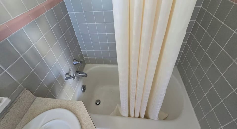 Soak and rinse comfortably in a tiled tub-shower combo
