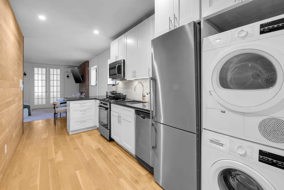 Modern kitchen with washer/dryer and seamless open layout