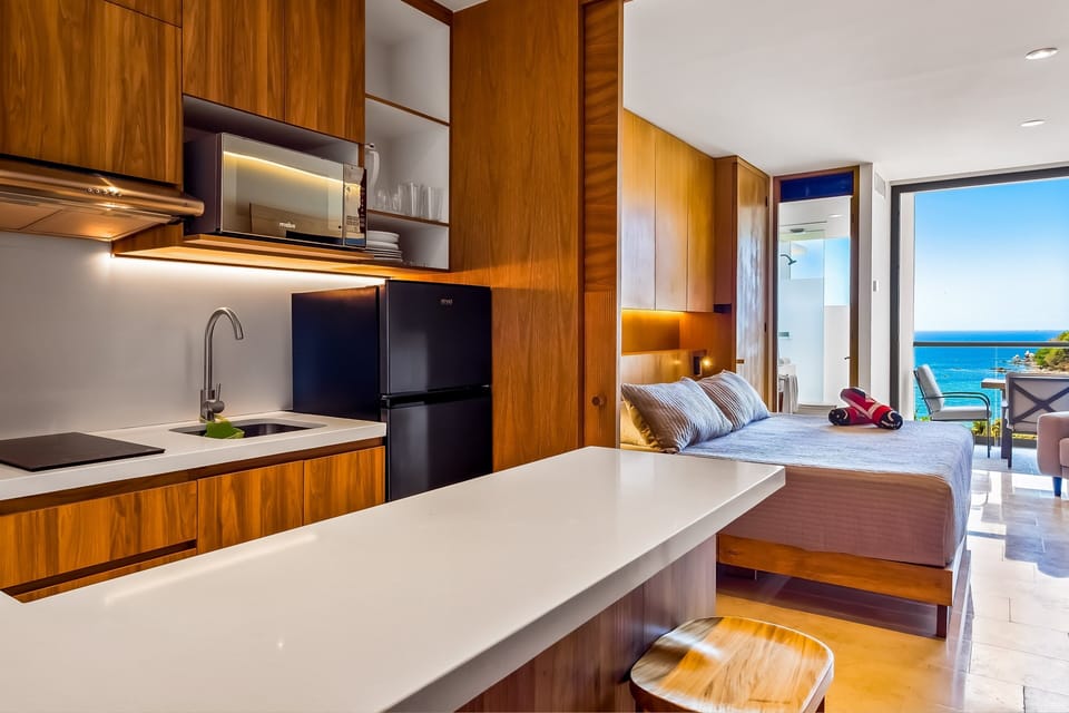 Enjoy a thoughtfully designed studio featuring a fully equipped kitchen, comfortable sleeping area, and ocean-view balcony access.