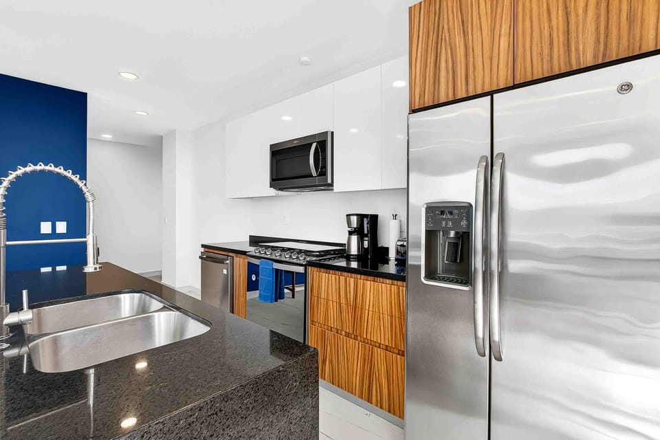 Cook with ease in a contemporary kitchen featuring stainless steel appliances, sleek finishes, and ample workspace.
