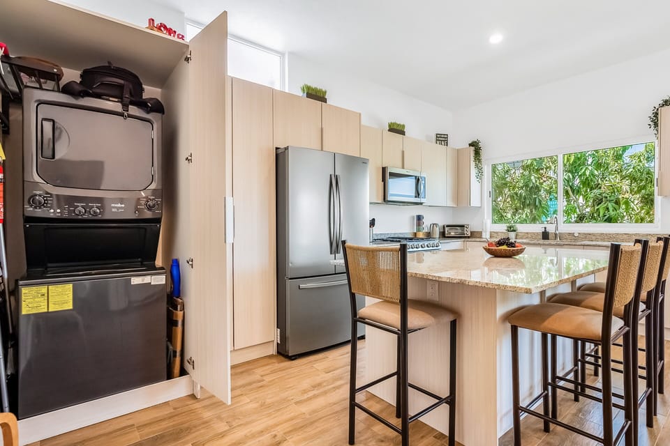 Modern kitchen with stainless steel appliances, generous storage, and a spacious island—perfect for preparing meals and gathering with family and friends.