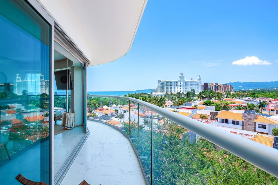 Step out onto your curved private balcony and take in sweeping views of the bay, mountains, and city below.