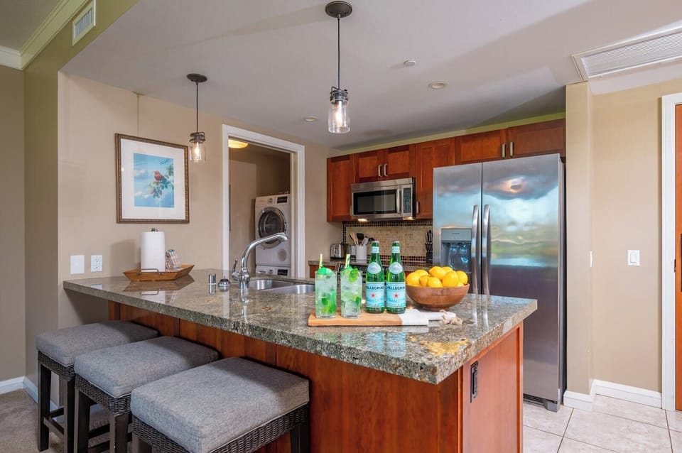 Modern kitchen with granite counters, stainless appliances, and everything needed for home-cooked meals. HKH-240