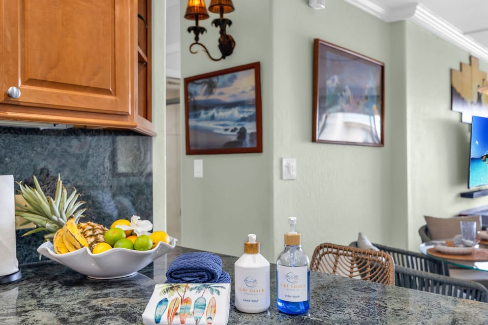 Fully equipped with stainless steel appliances, warm wood cabinetry, and dark stone countertops for easy meal prep. 