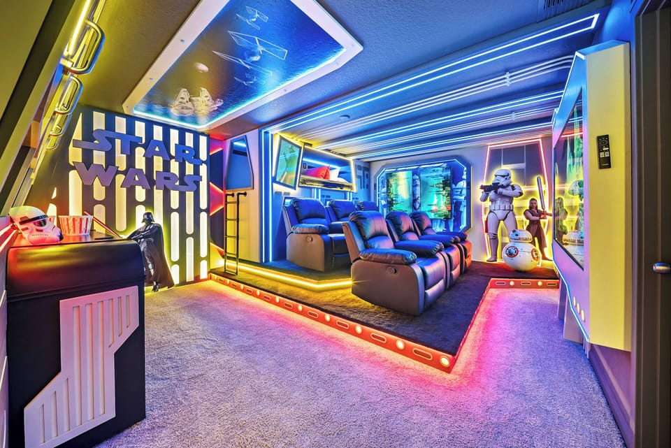 Enjoy an exciting entertainment room with vibrant neon lights and modern decor. Relax in cozy recliners while taking in immersive wall art, creating the perfect cinematic atmosphere for your movie nights.