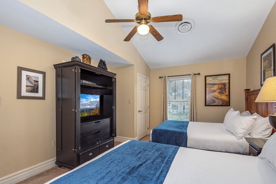 Unwind in your comfortable twin bedroom with flat-screen TV, ceiling fan, and peaceful mountain views from your window.