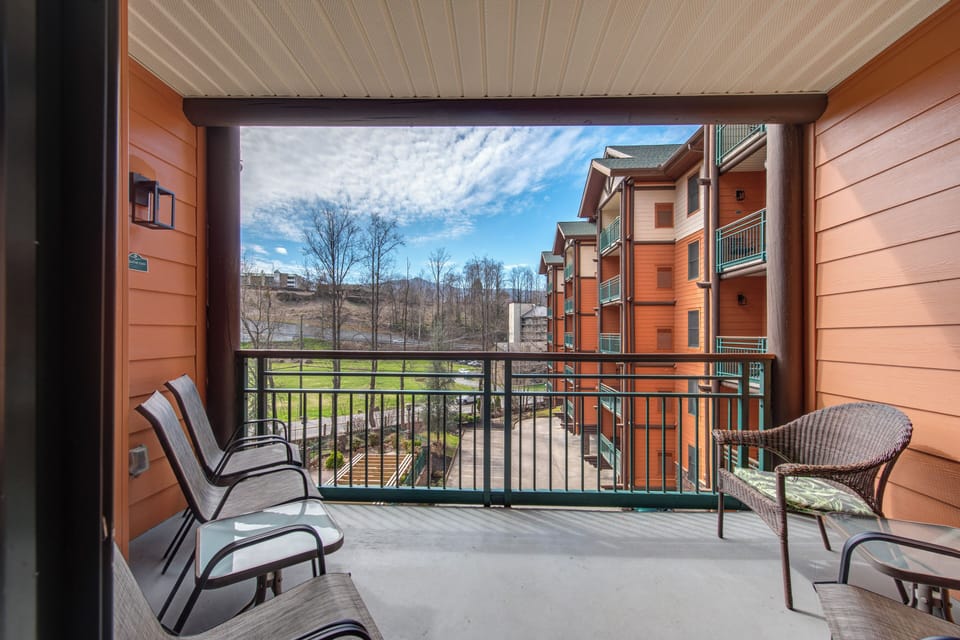 Step onto your private balcony and breathe in the fresh mountain air while enjoying comfortable seating with views of the surrounding buildings and landscape.