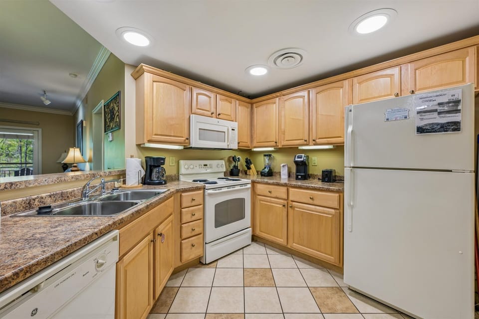 Whip up your morning coffee in this fully-equipped kitchen with granite counters, modern appliances, and everything you need for a perfect home-cooked meal.