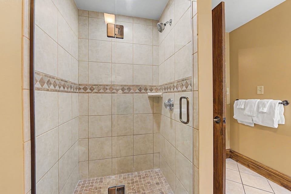 Step into your spacious walk-in shower with elegant tile work and premium fixtures for a truly refreshing experience.