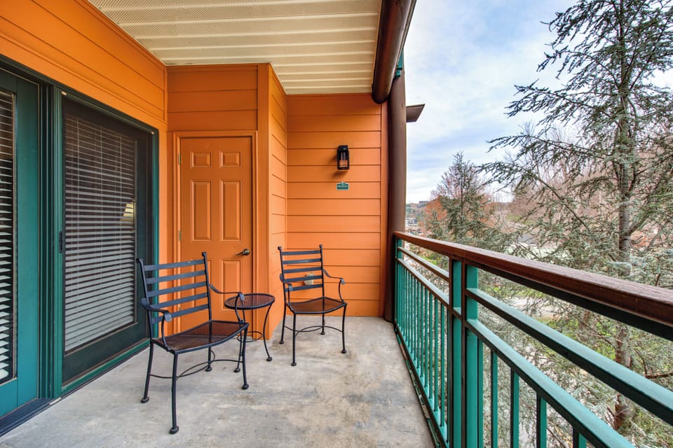 Step onto your private balcony and breathe in the fresh mountain air while enjoying peaceful forest views from your comfortable seating area.