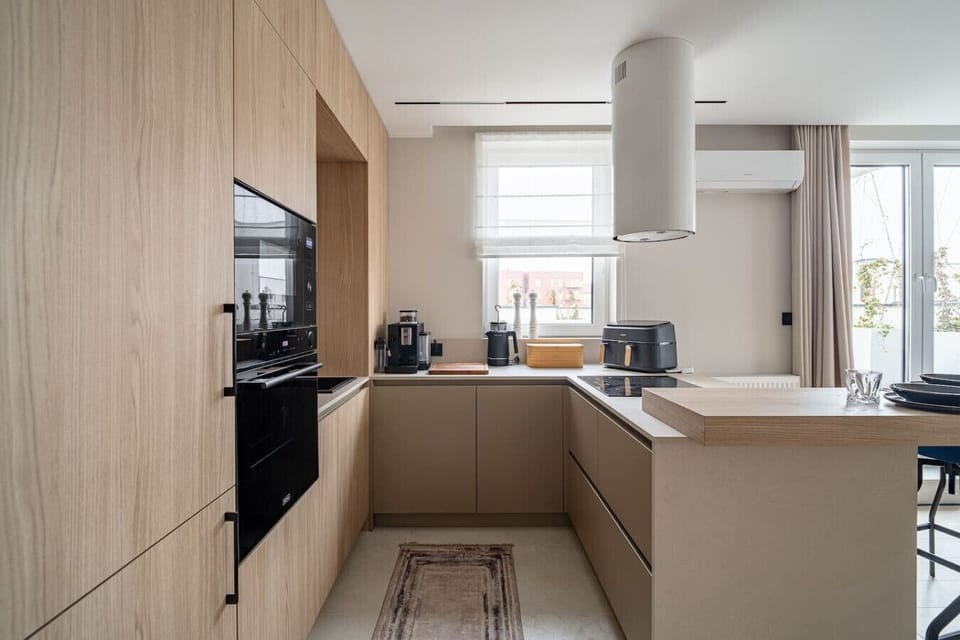 Modern Kitchen with Island, Coffee Machine and Dining Space | Book Now with RENTUJEMY.COM