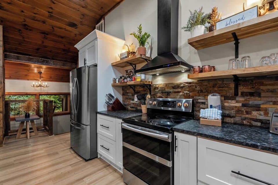 Rustic-modern kitchen with vaulted wood ceilings and sleek appliances