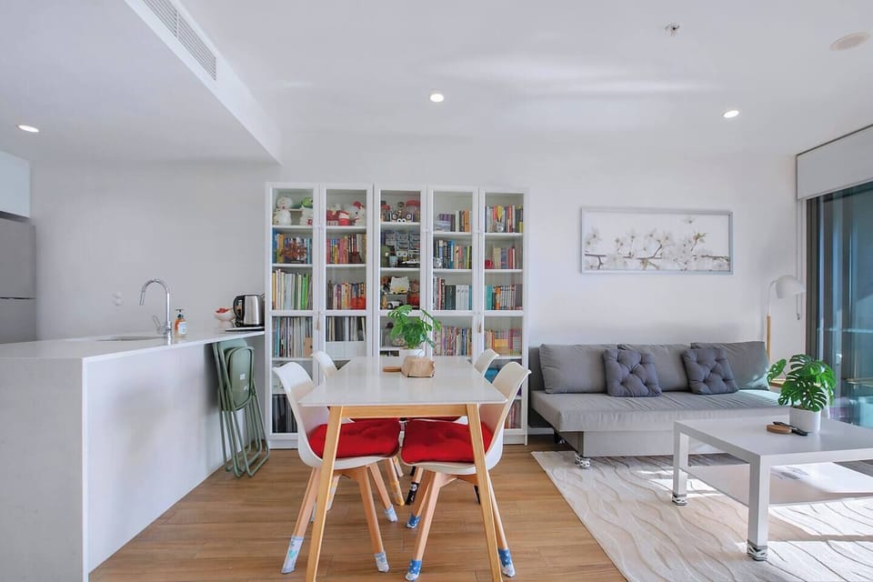 Gather around the dining table for shared meals or a casual workspace bathed in natural light.