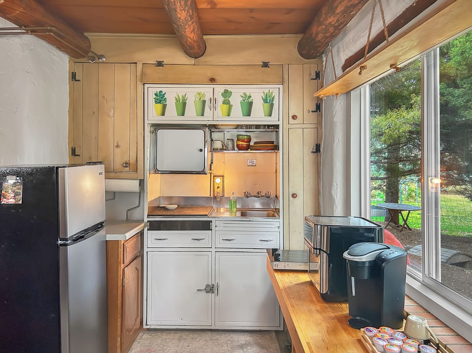 Kitchenette features a Keurig coffee machine, air fryer, medium sized fridge, and induction burner.