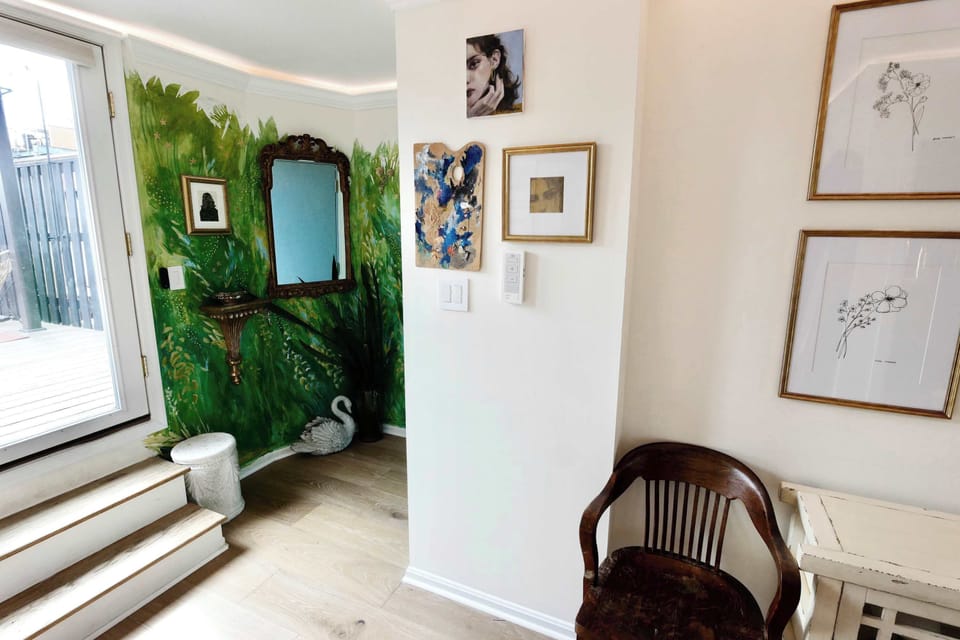 Green “garden” mural by the deck entrance adds a whimsical, secret‑garden feel as you step outside.