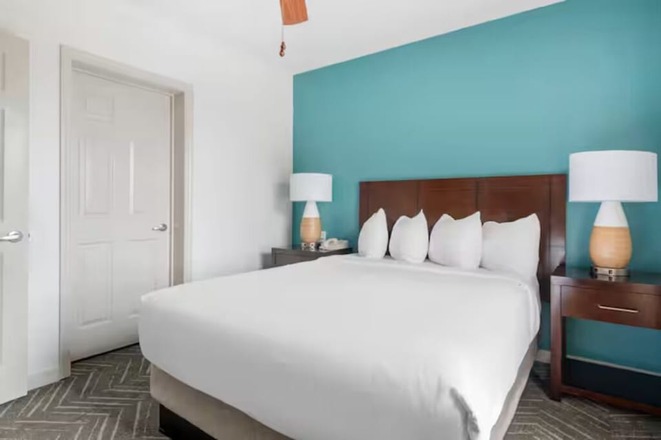 Sink into a quiet king bed framed by soothing colors.